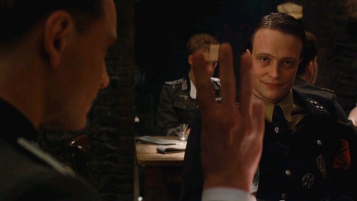 A tense conversation and a three-finger gesture in a cellar tavern.
